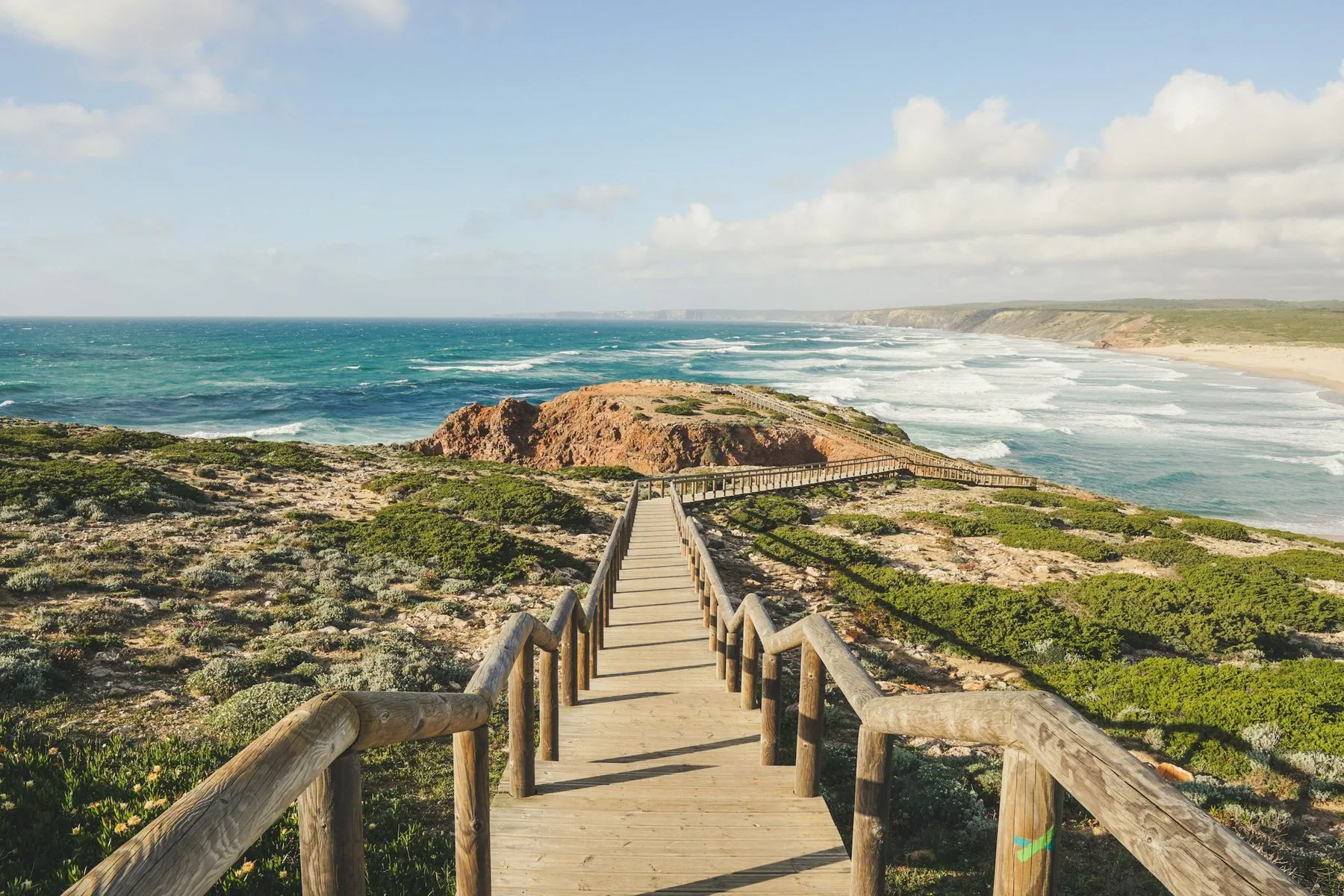 Den vide sandstranden Praia da Bordeira på vestkysten av Algarve med klipper og brenninger
