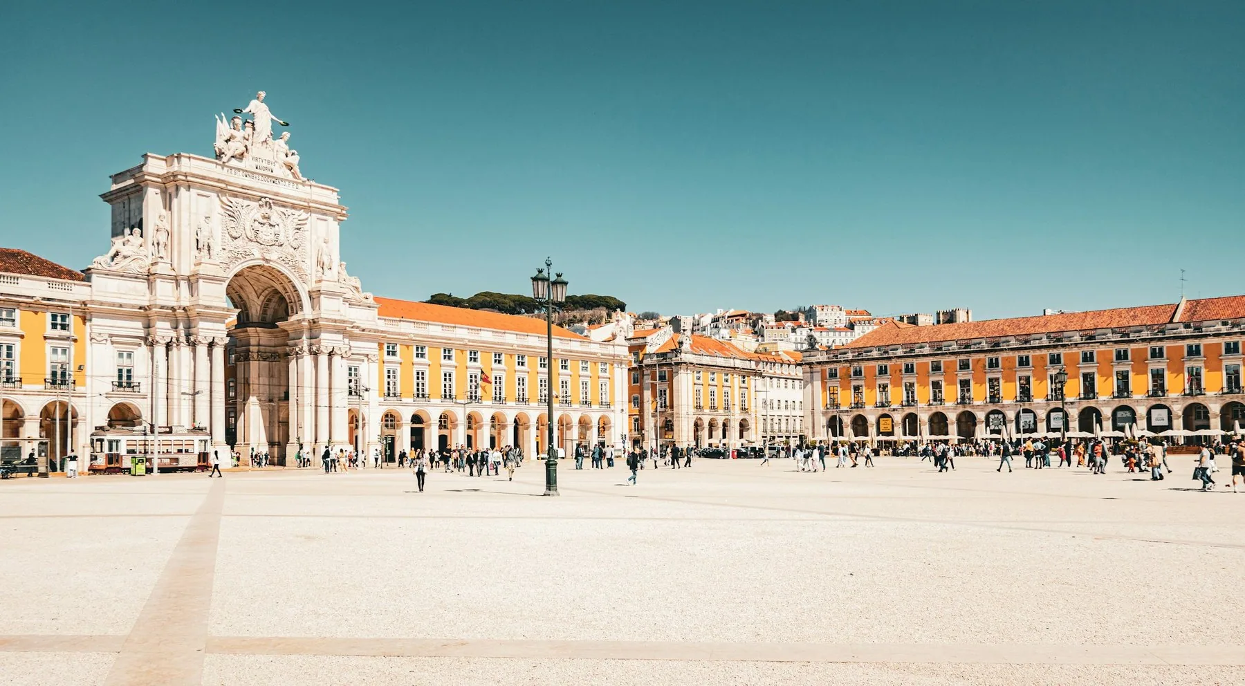 Den store plassen Praca do Comercio i Lisboa med de gule bygningene rundt
